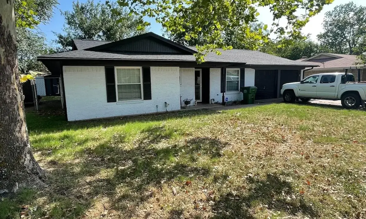 Professional roofing crew working on a residential roof in Tupelo